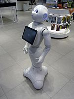 A friendly robot with a screen on the chest in a department store