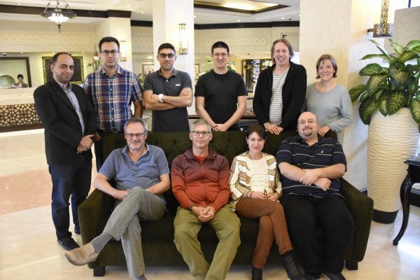 The group of ten authors sitting on a couch