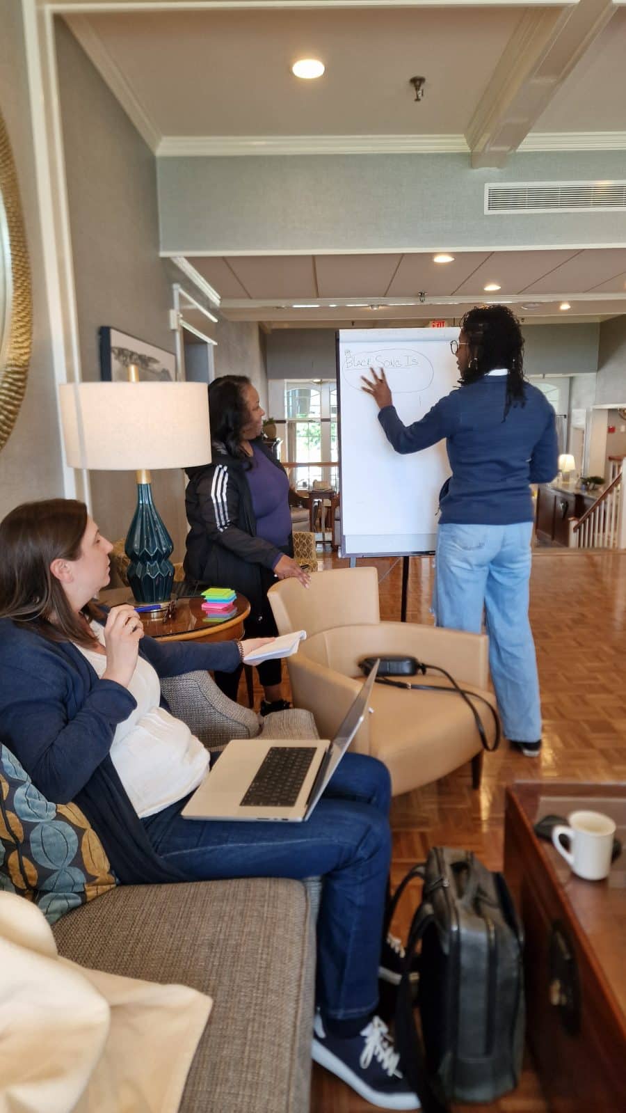 Three women collaborating on a flipchart